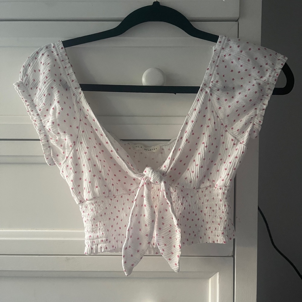white crop with pink flowers